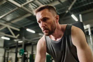 Stock photograph of a man resting after a gym workout; illustrative only.