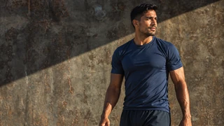 AI-generated illustrative model in a navy athletic shirt; not an Impact MD patient or clinician.