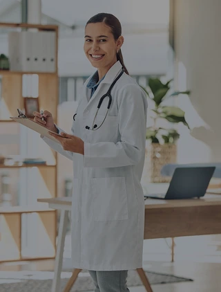 Stock photograph of a physician holding a clipboard.