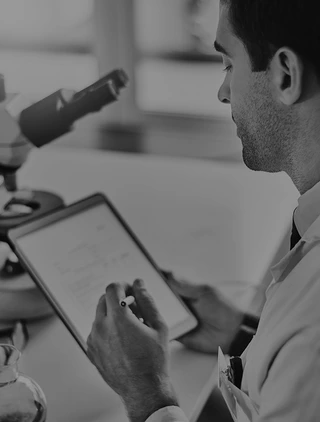 Stock photograph of a laboratory professional reviewing samples.
